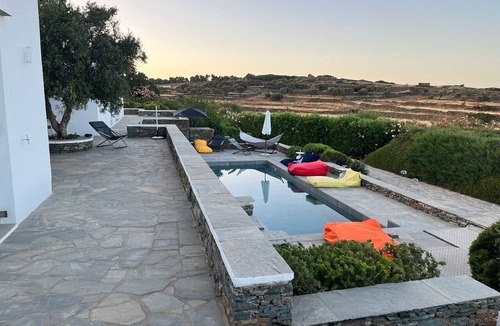 Platis Gialos House | A quiet Cycladic-style family home with a pool and an exceptional ocean view.